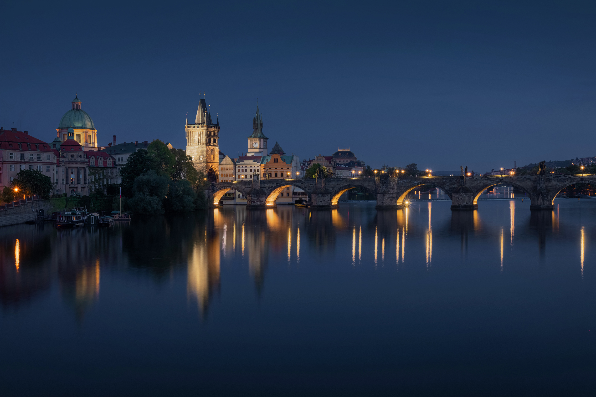 Prague skyline and bridge over river at night. Czech Republic.