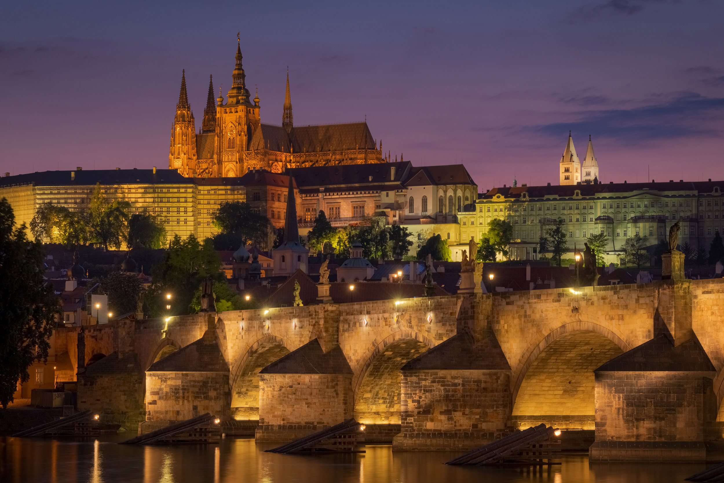View of the castle and Charles bridge in Prague after the sunset