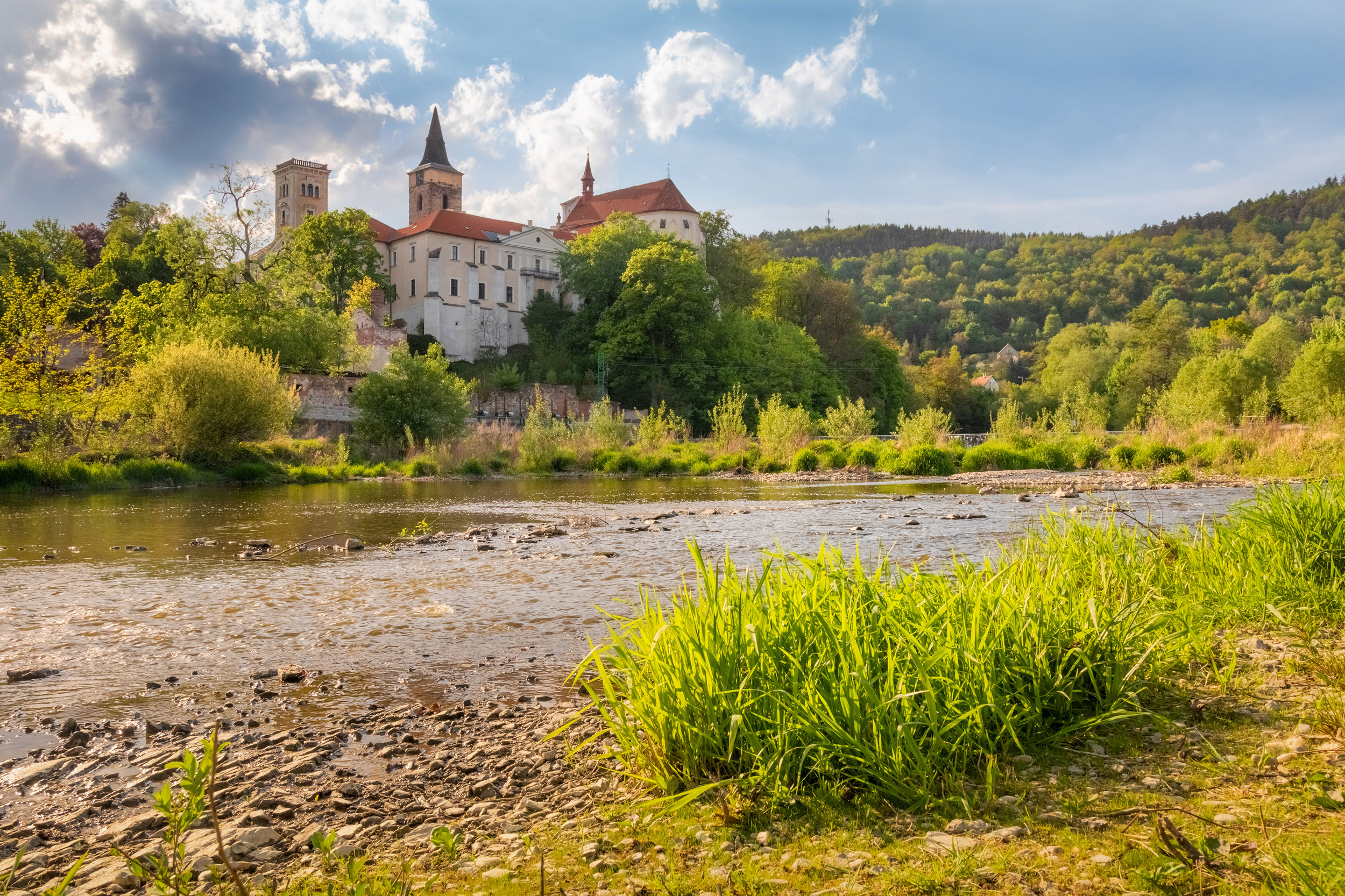 Sunny day in Sazava monastery with grass and river foreground, C