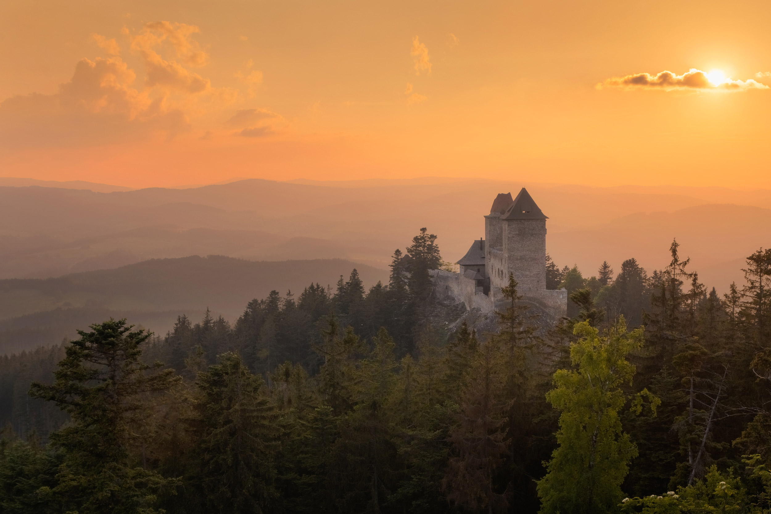 Golden sunset in Kasperk castle, Sumava, Czech Republic. Hills a