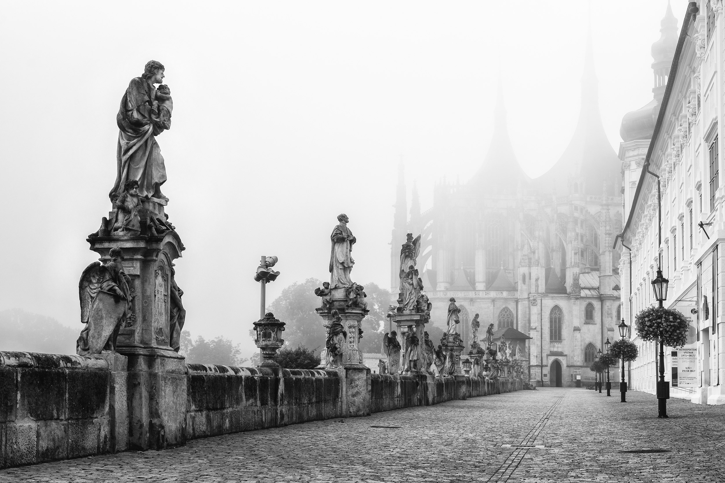 Statues in front of misty St. Barbara’s Church in Kutna Hora, Cz