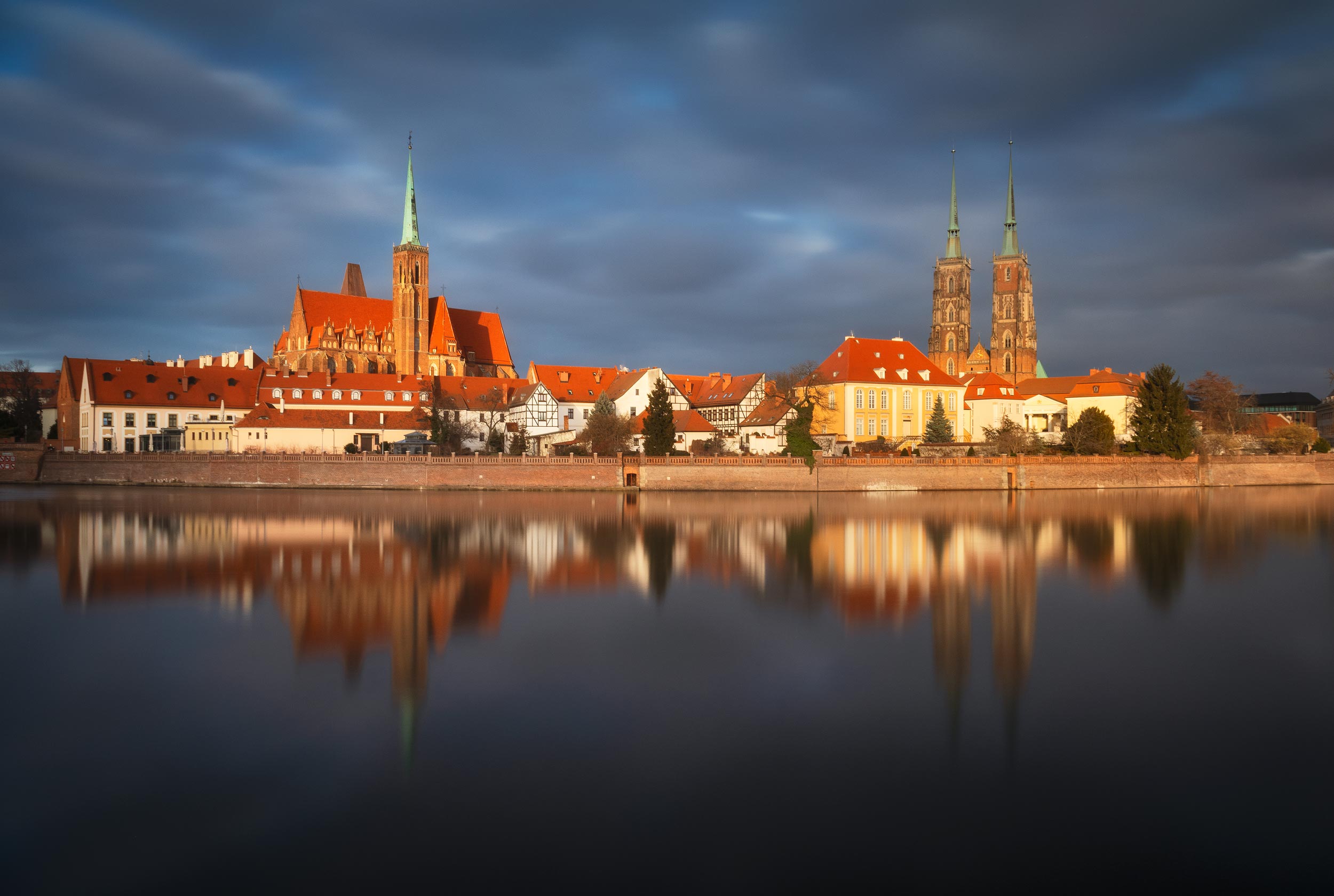Cathedral of St. John the Baptist reflected in Odra River at sunset, Wroclaw