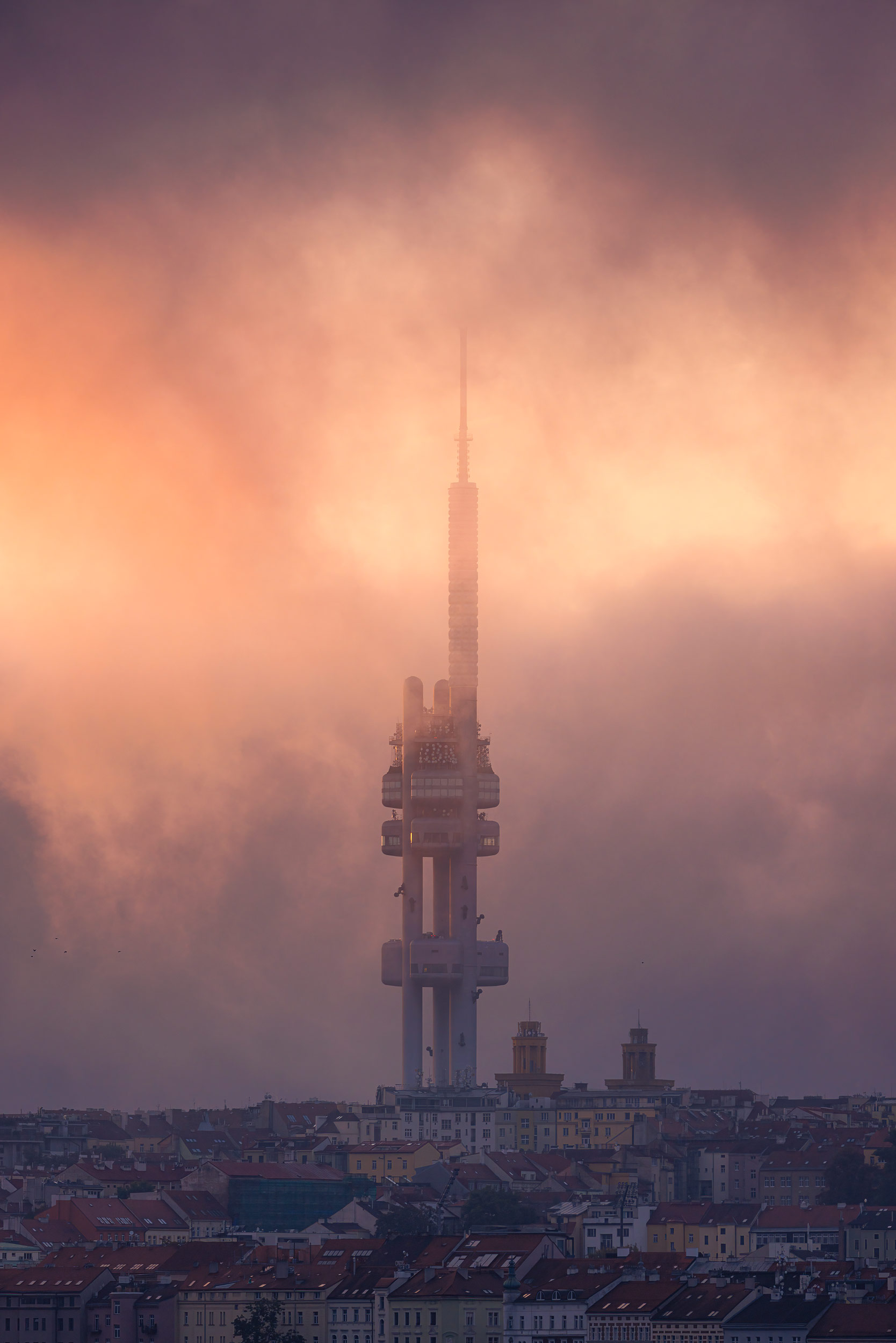 Žižkov Television Tower in fog and pink clouds, Prague